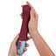 FemmeFunn - Lola G - ergonomically curved, flexible G-spot vibrator has an angled head & a wavy rippled texture on a soft liquid silicone body. Maroon, in hand