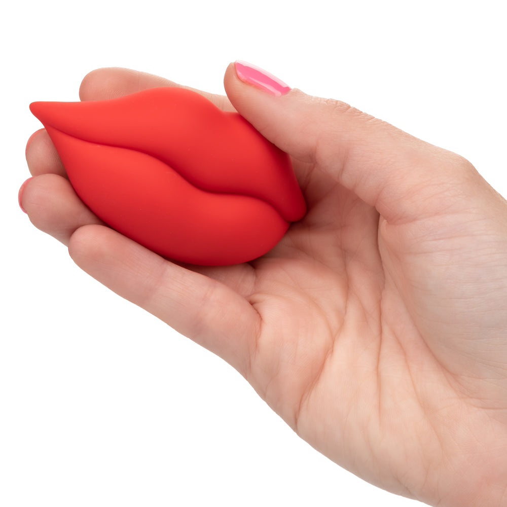 Naughty Bits Muah Mini Vibrator - palm-sized handheld massager fits perfectly between your fingers & delivers 10 awesome vibration patterns through its fun lip-shaped design. Red 2