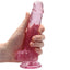 RealRock 7" Crystal Clear Realistic Dildo With Balls & Suction Cup has a lifelike shape & size w/ 5.9" insertable & a ridged phallic head, veiny shaft + testicles for safe anal or vaginal play. Pink-on hand.