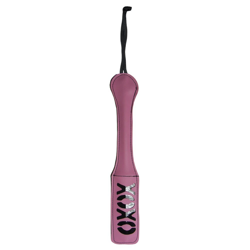 Sex & Mischief XOXO Imprint Spanking Paddle sports an XOXO cutout design to leave an impression of your love on your sub's skin. Pink.