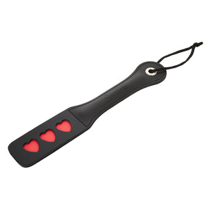 Sportsheets Leather Triple Heart Impression Paddle is engraved w/ 3 red hearts that leave impressions on your sub's skin to show just how much you love them.