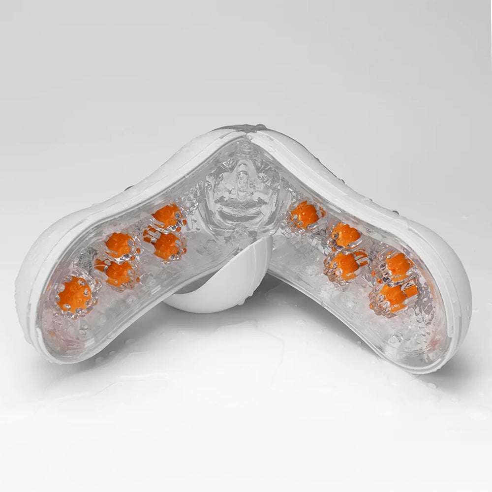 Tenga Flip-Open Orb Masturbator - Orange Crash has pleasure nubs & firm orbs inside soft elastomer on flexible stalks that ripple & bounce around you for a wicked layered sensation. Drying.