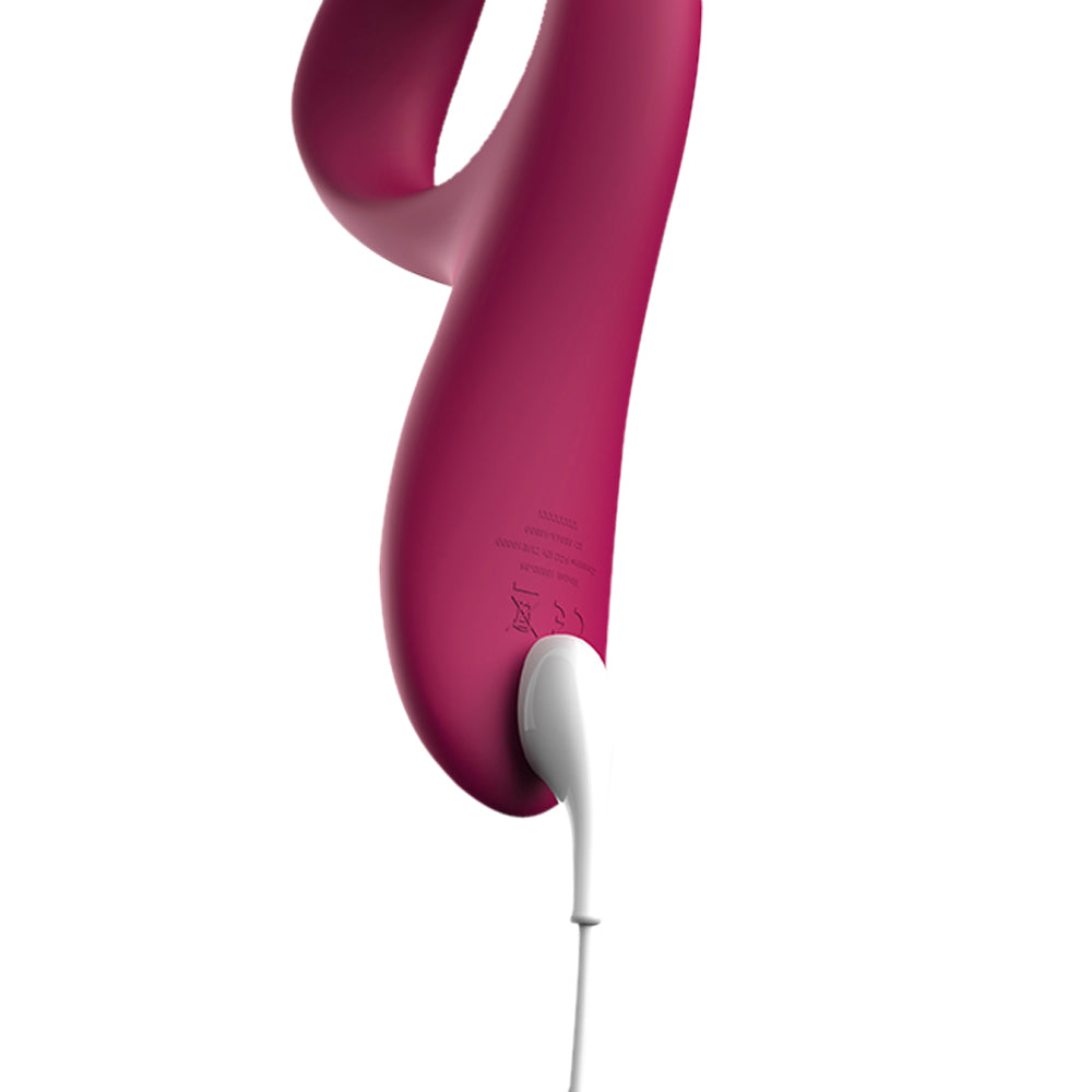 Close-up of the We-Vibe Nova 2's magnetic charging cable attached behind the base of the rabbit vibrator.